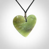 A hand carved heart pendant made from New Zealand jade.
